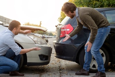 Men argue over responsibilities following a car accident.