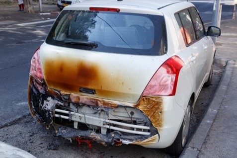 A Suzuki Swift is damaged by a fire at the rear