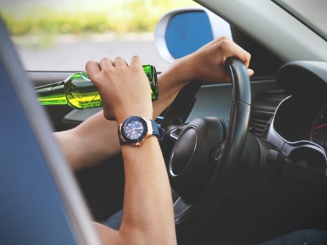 Person drinks while driving