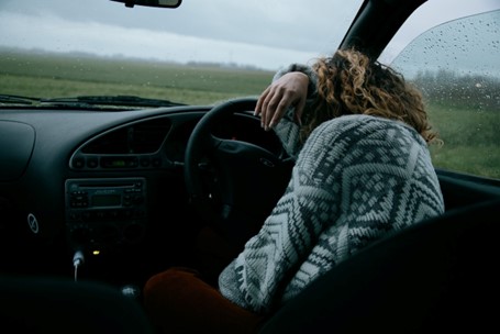 Person sleeps behind the wheel